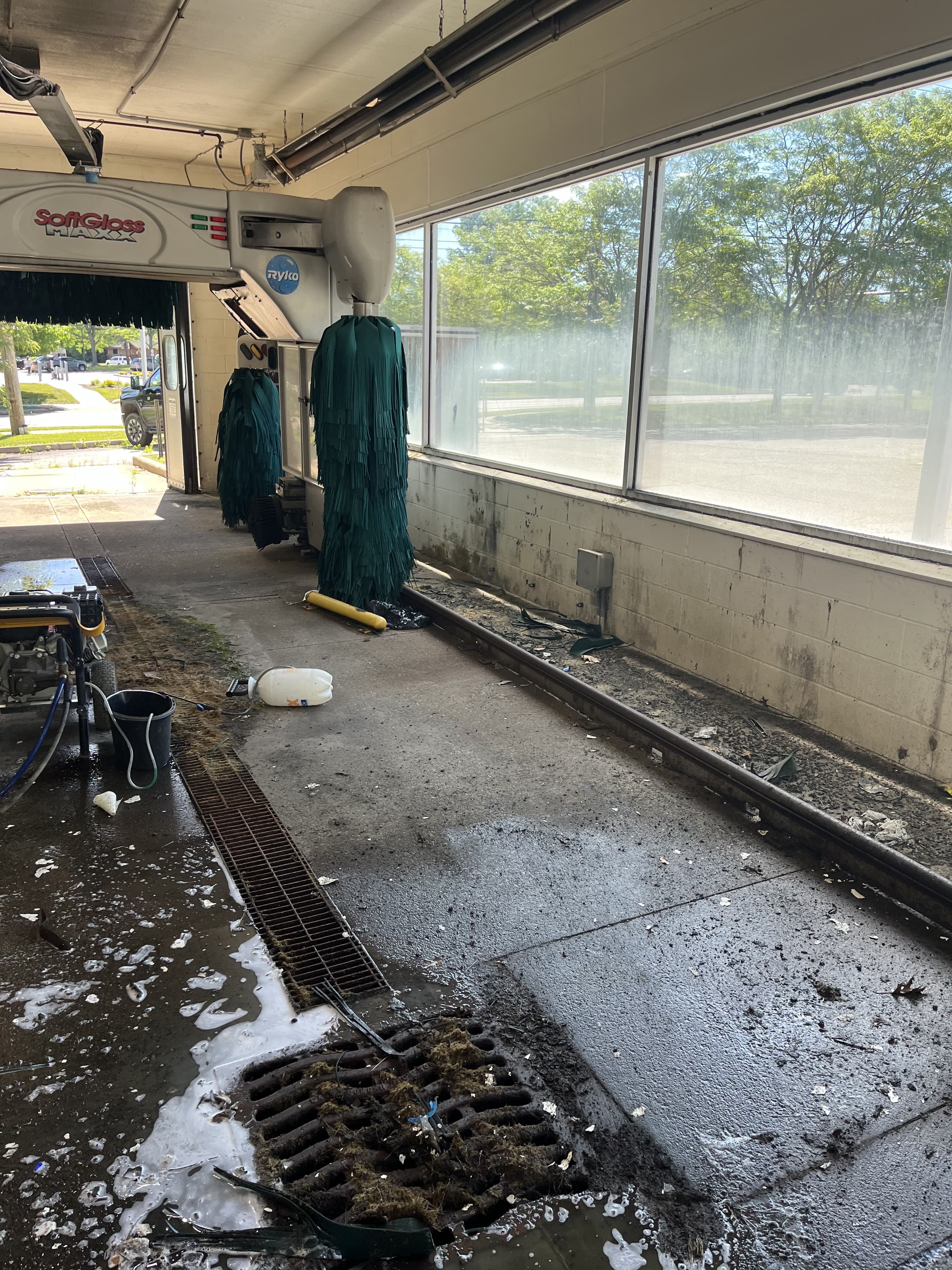 Commercial bay drain and floor area during cleanup and repair work.