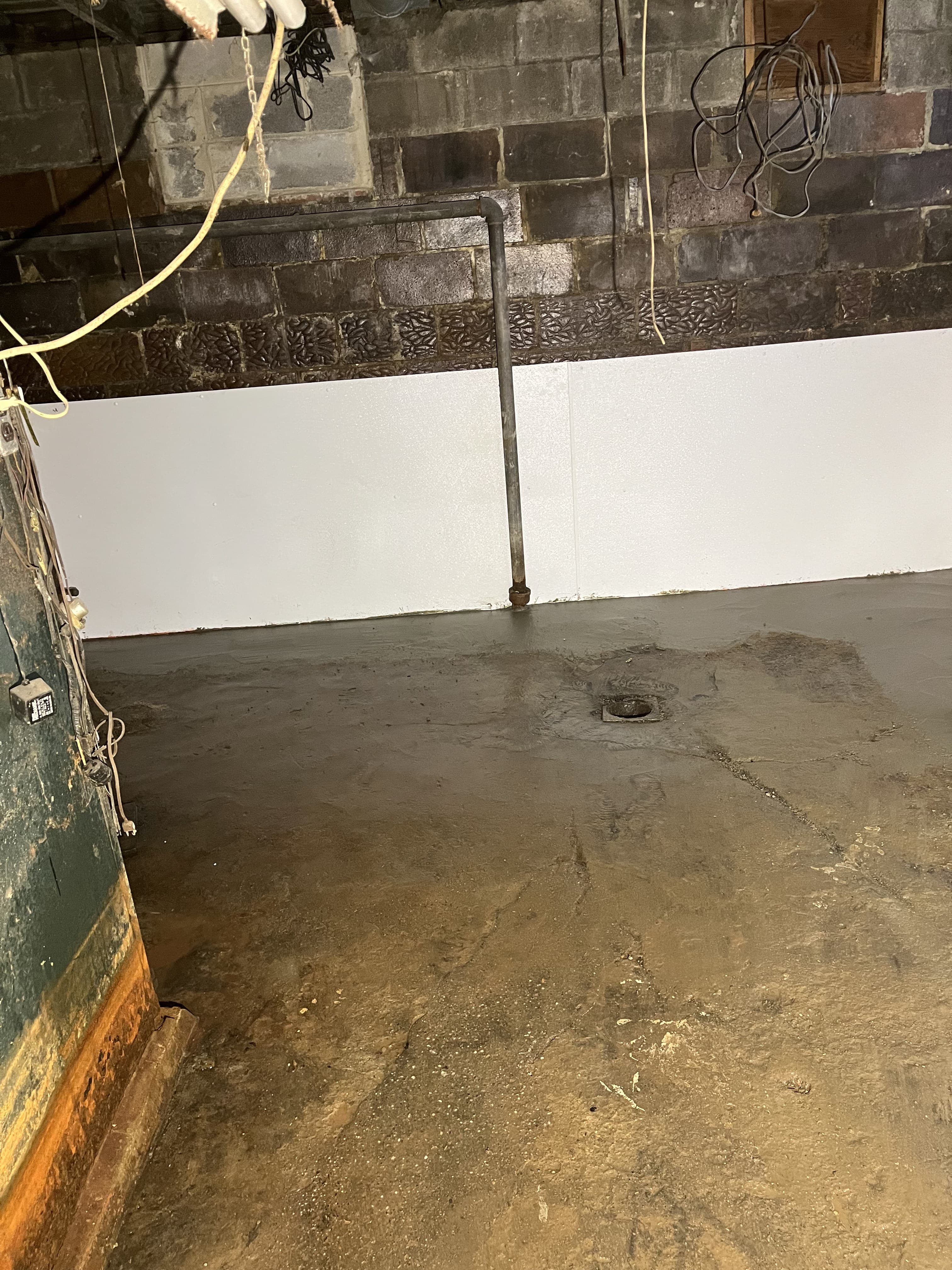 Basement slab section with fresh concrete repair.