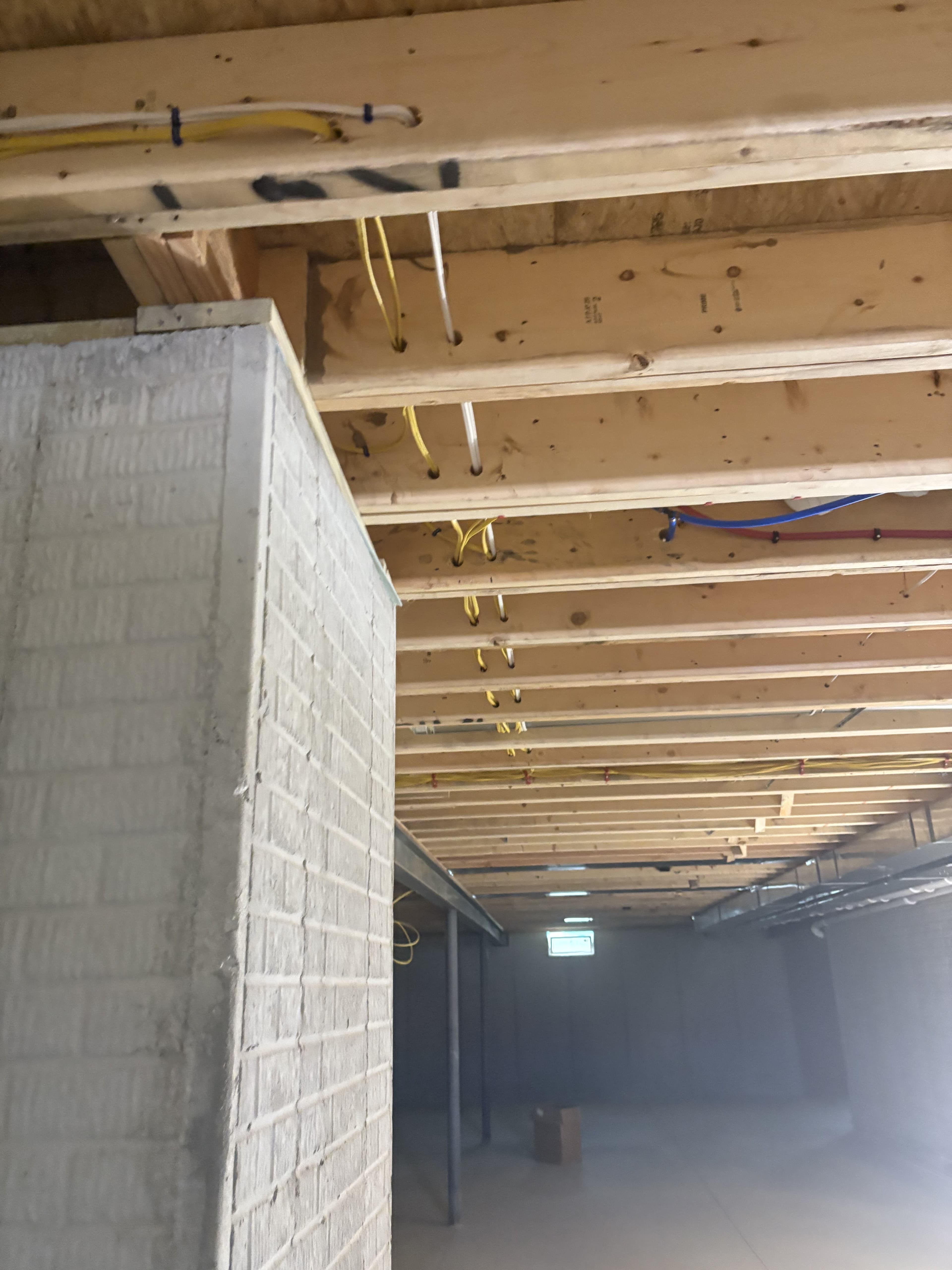Electrical prep work alongside a painted block wall.