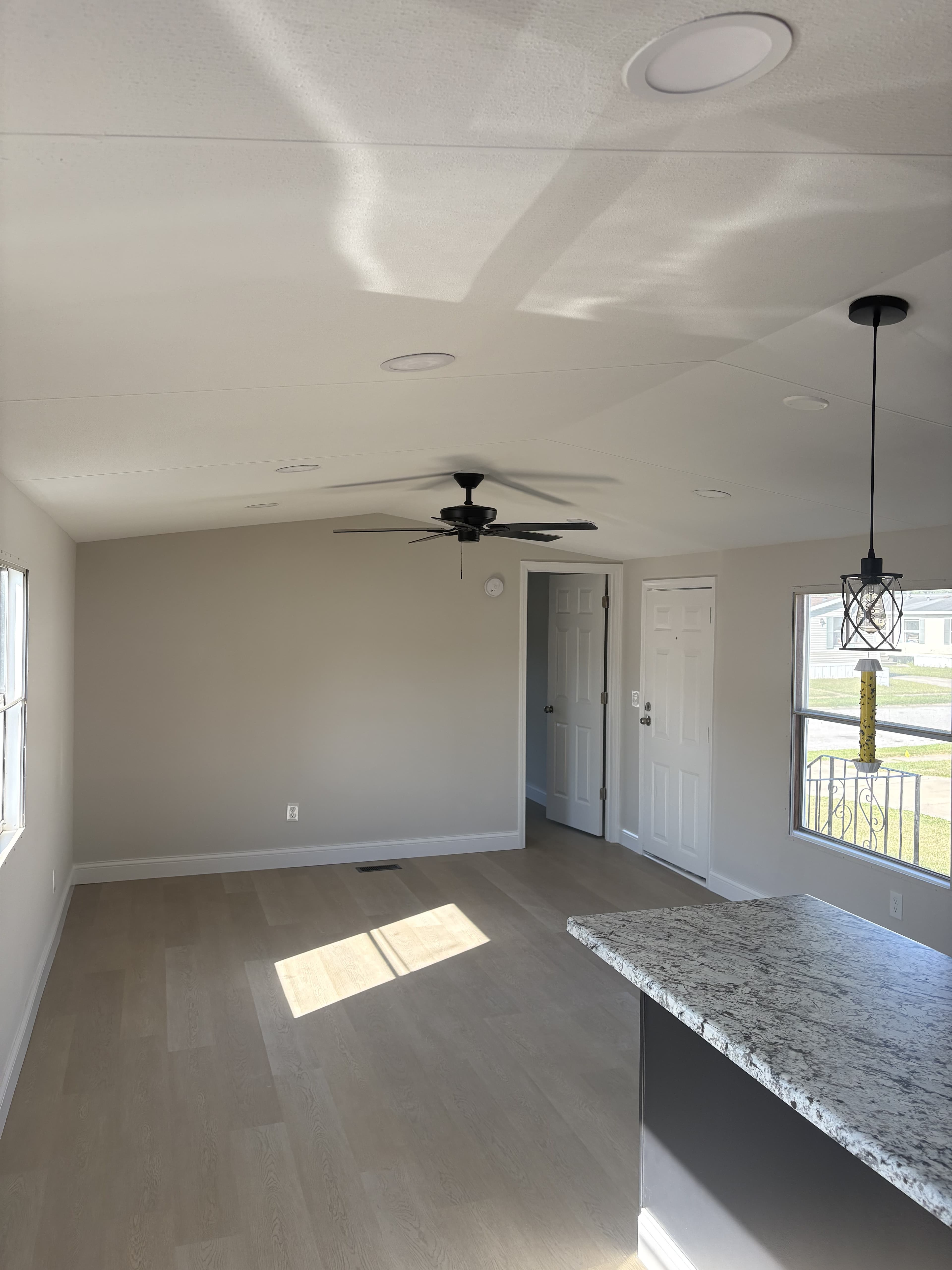Finished residential living space with natural light and ceiling fan.