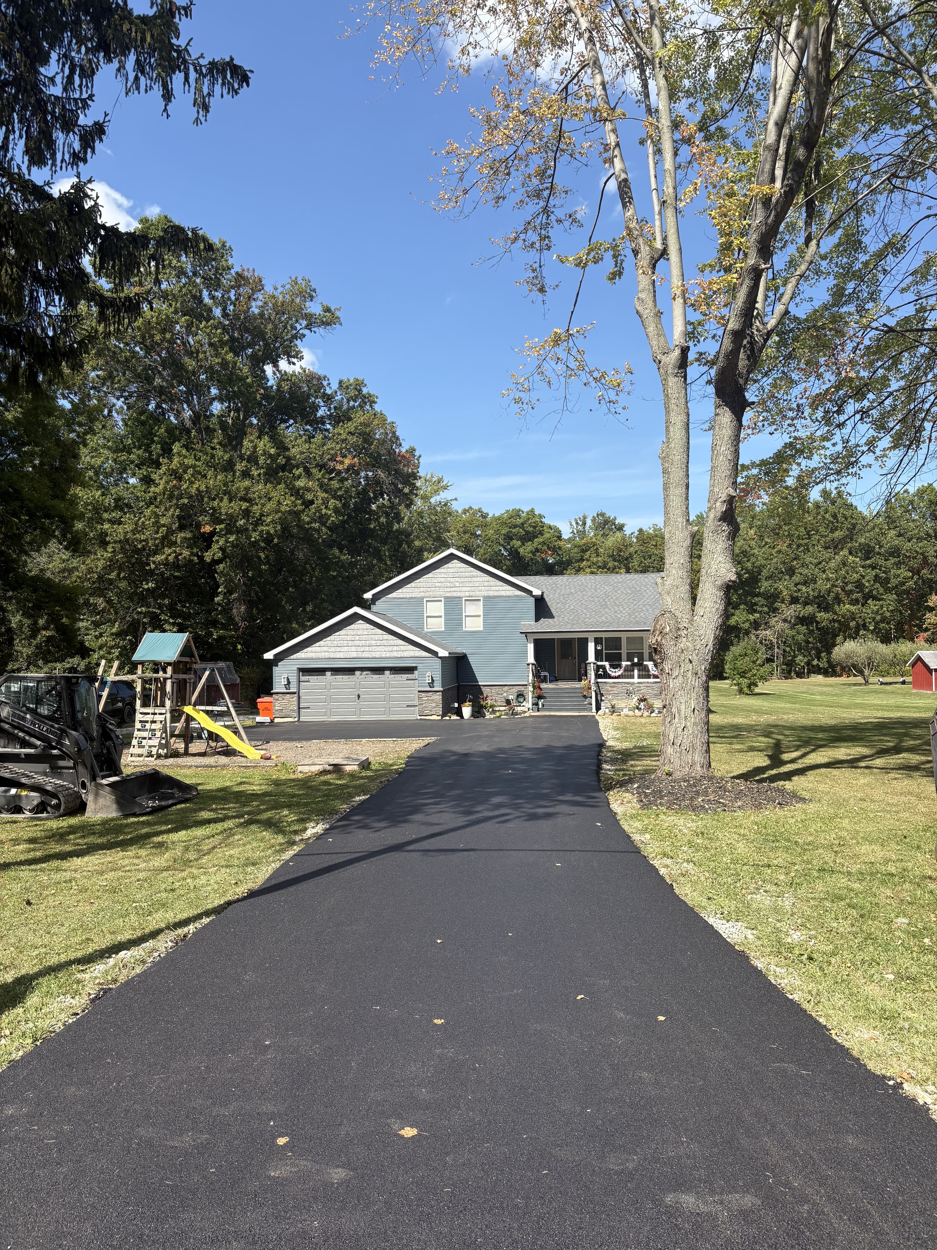 Finished residential exterior with fresh driveway and updated front approach.