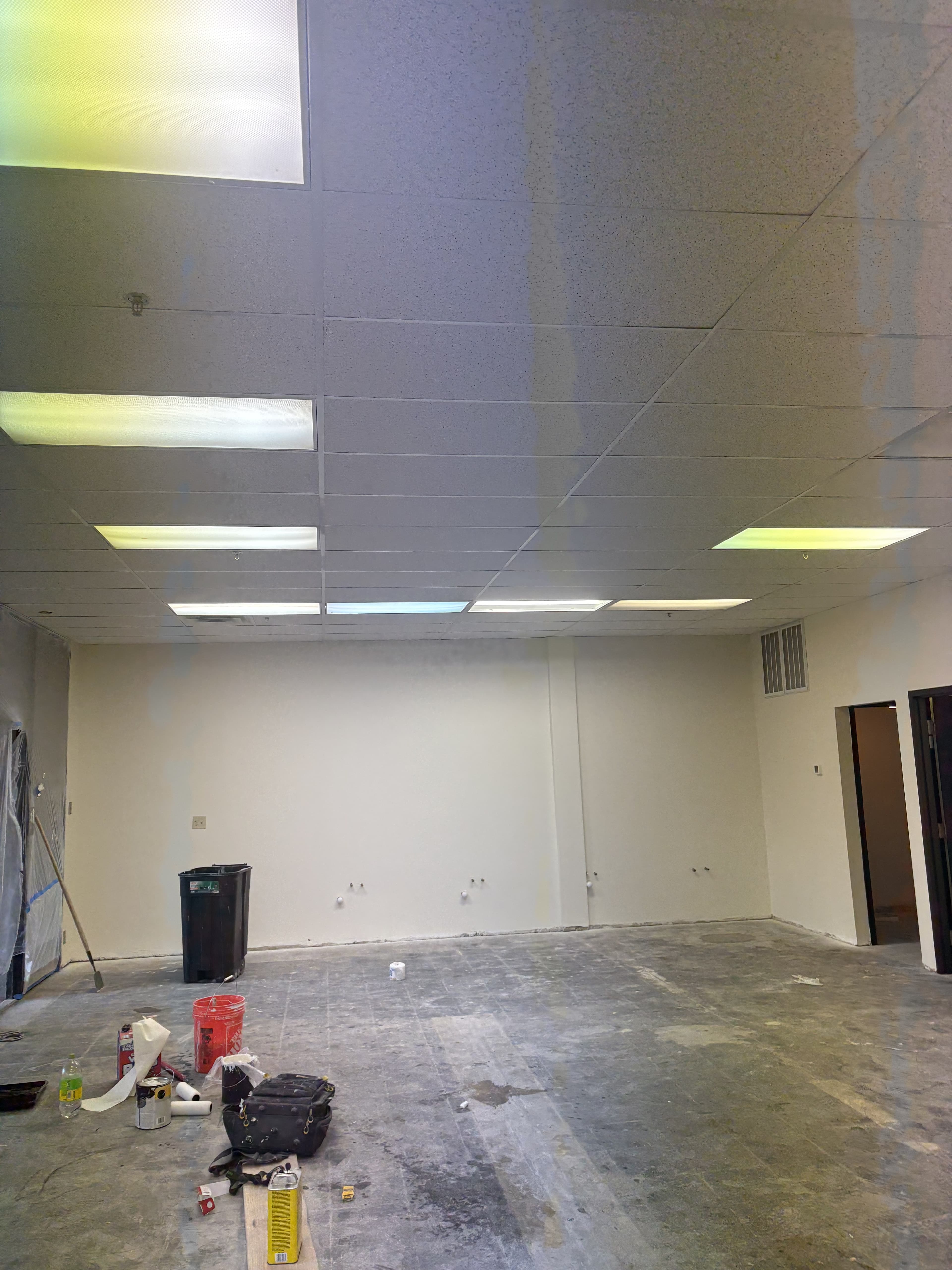 Commercial room with energized overhead lighting during build-out.
