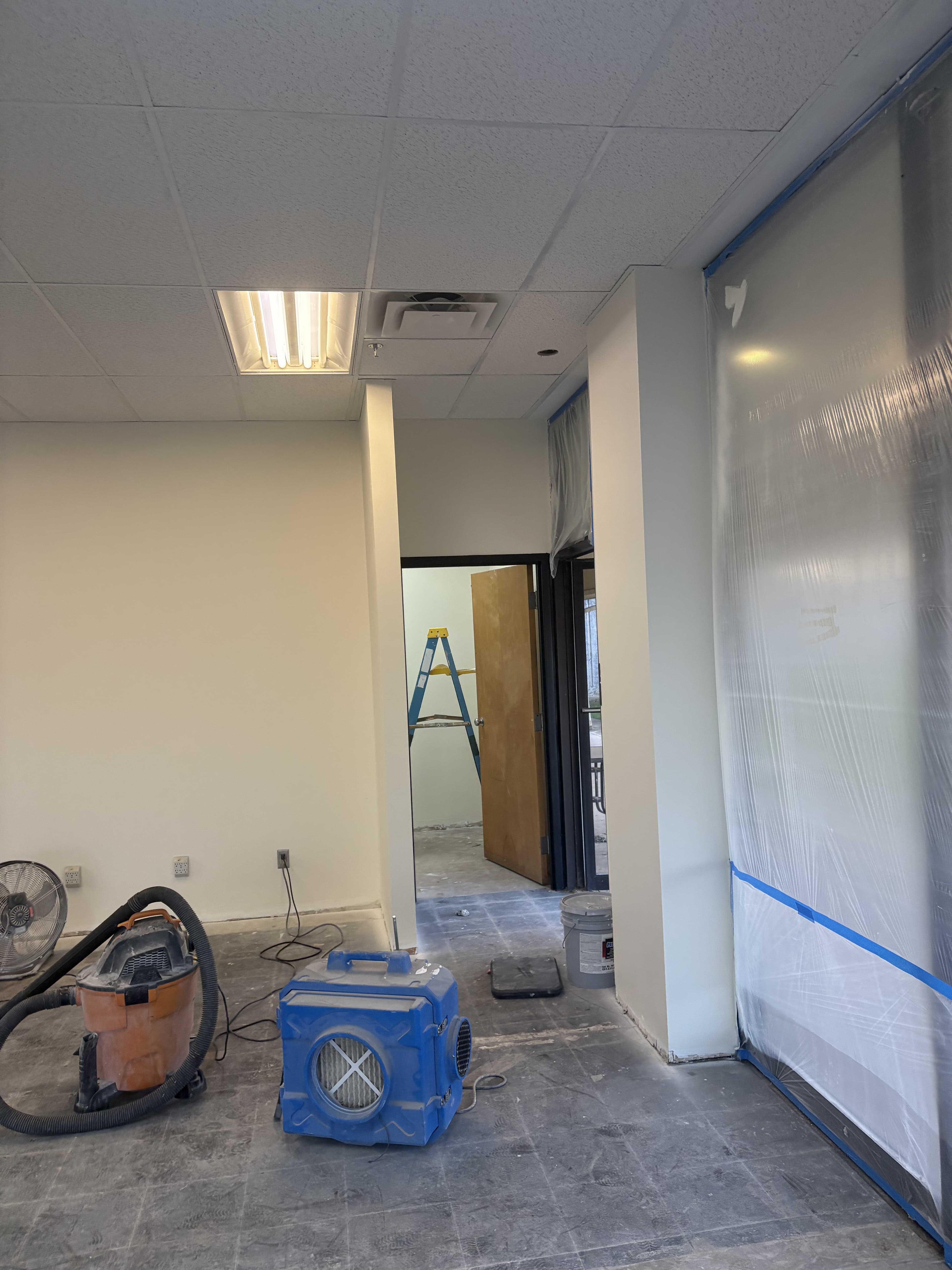 Hallway and adjacent room during late-stage interior build-out.