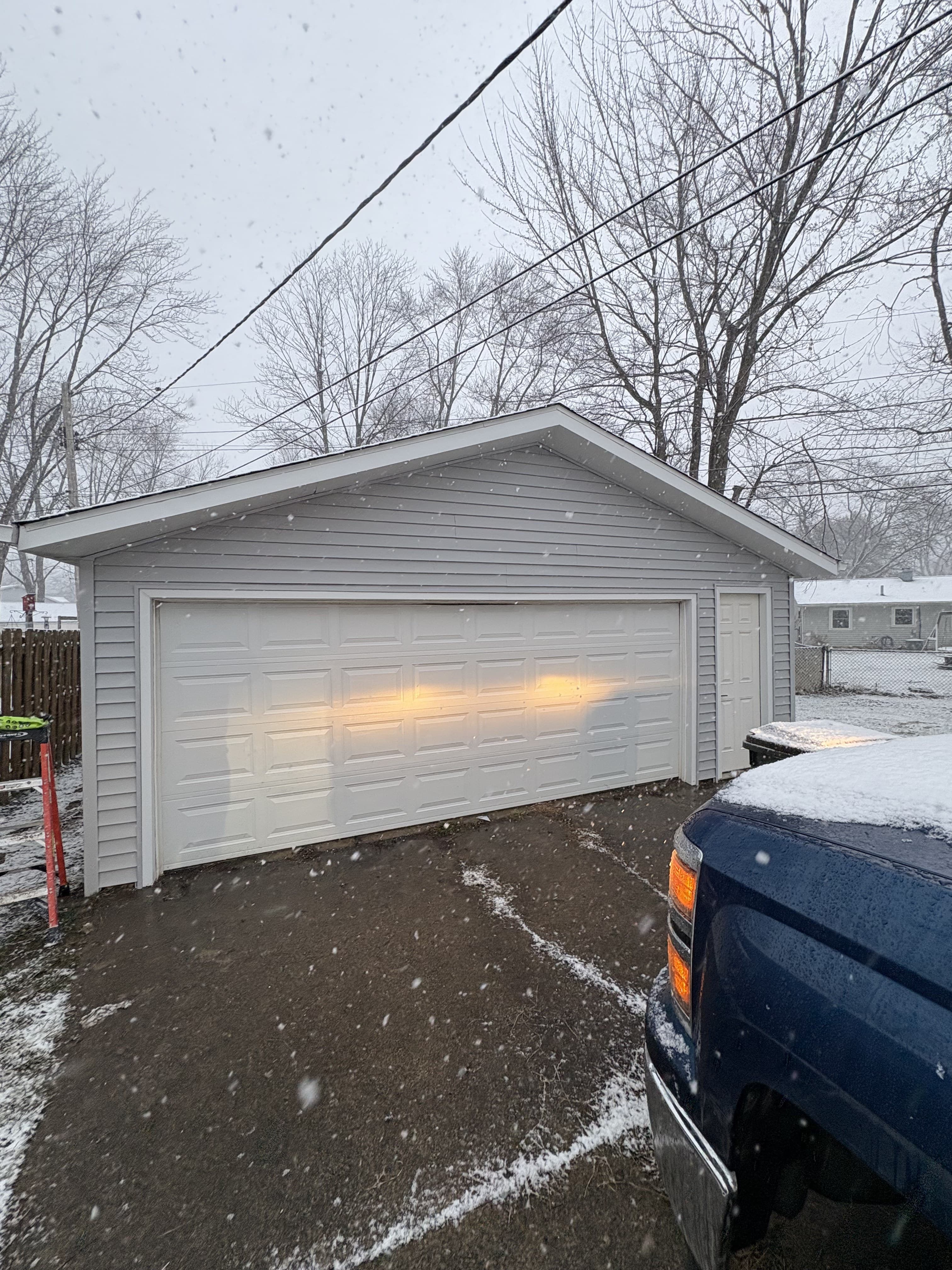 Detached garage with finished driveway and cleaned-up exterior approach.